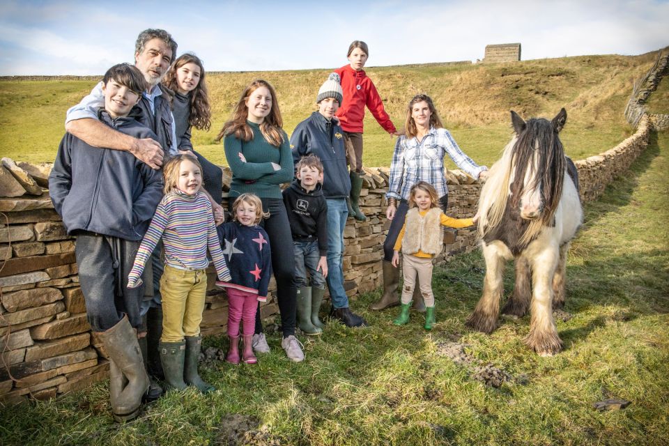 Amanda, Clive and their nine children on the farm