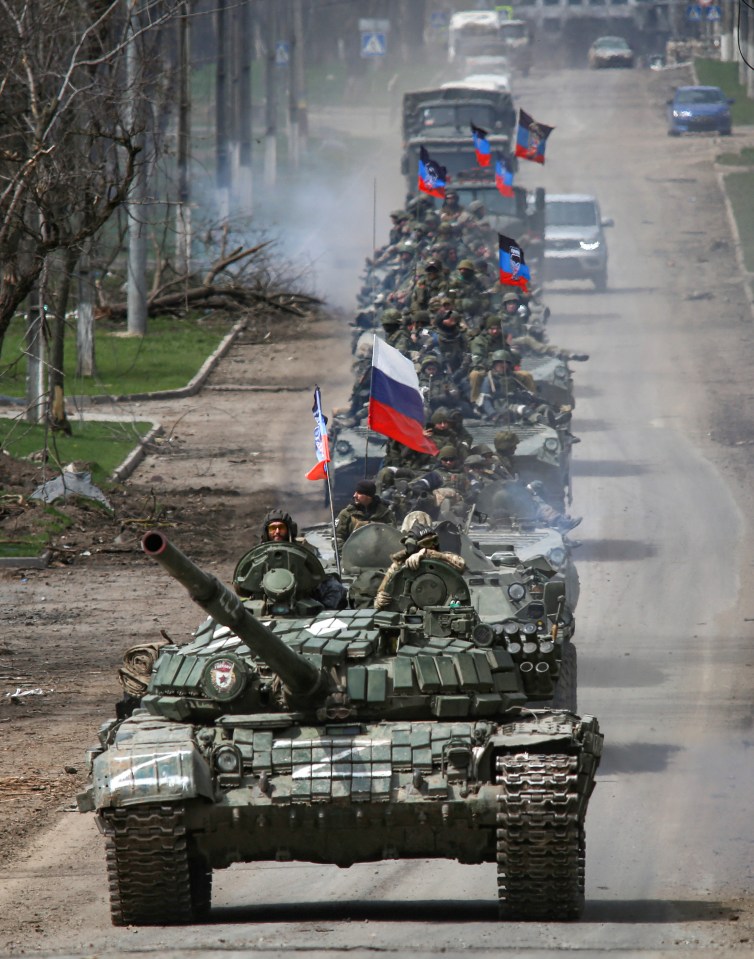 Russian tanks rolling down a road in Ukraine