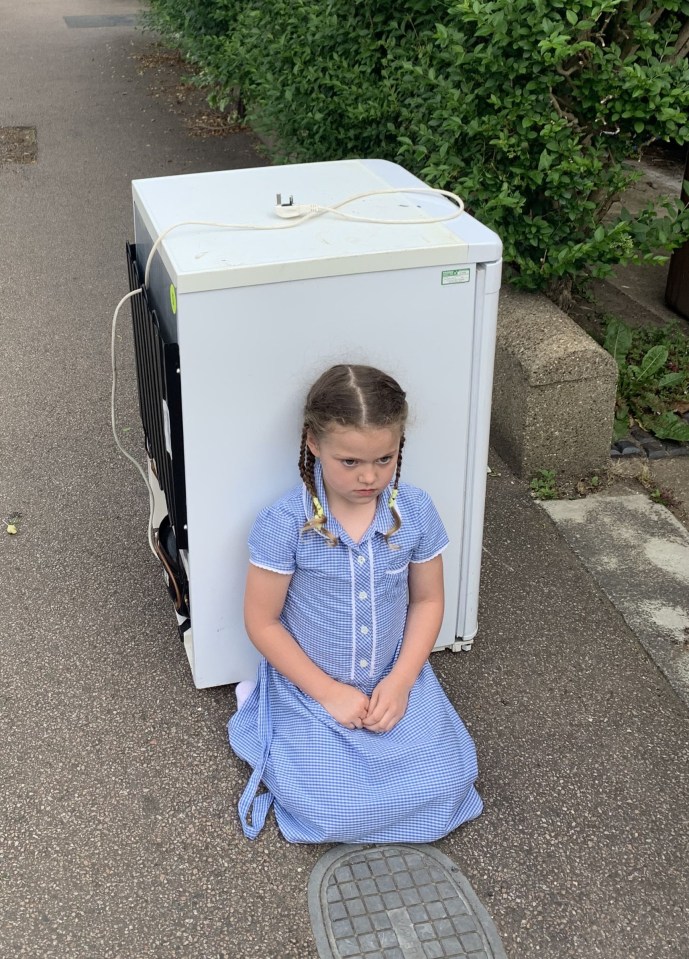 Louise Warren got her daughter Lyza Beau Ellis, 6, to pose in front of an old fridge when the passport office kept rejecting her photos