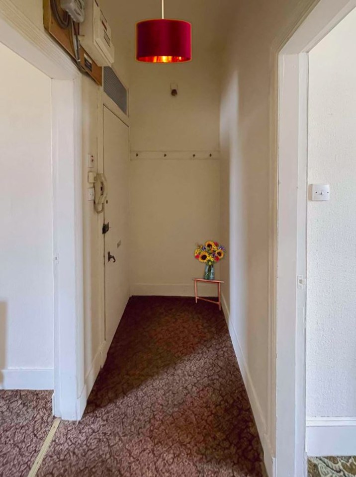 A vase and overhead light appear to have been added to the hallway