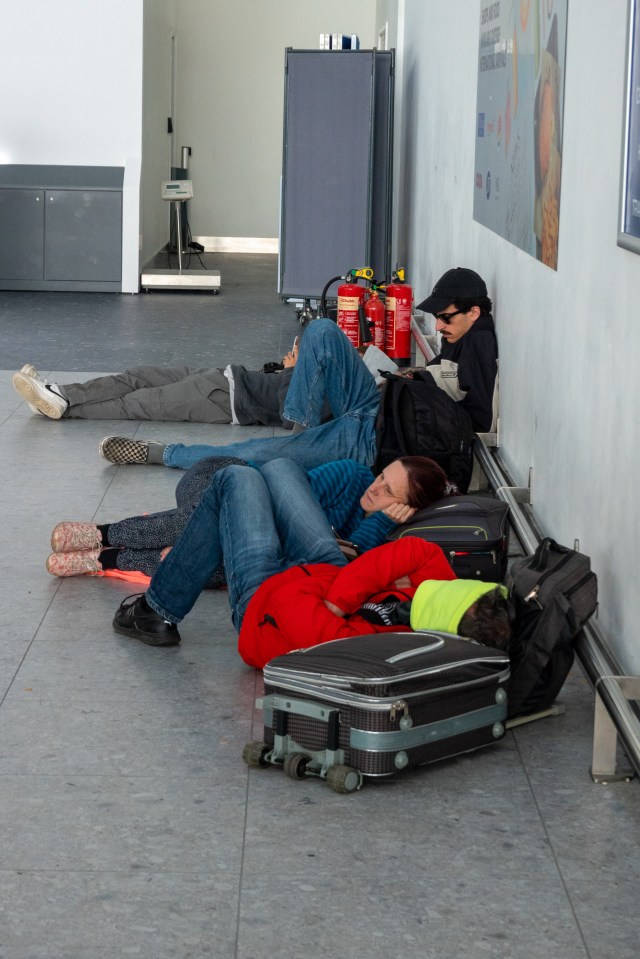 Frazzled travellers were pictured sleeping on the floor of the departure lounge