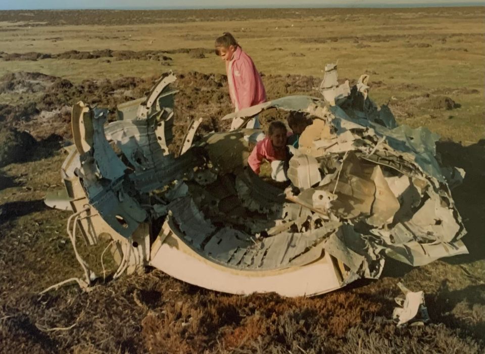 Sara Halford playing among wreckage from the Falklands conflict as as child