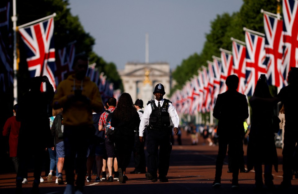 A police officer walks down The Mall in London