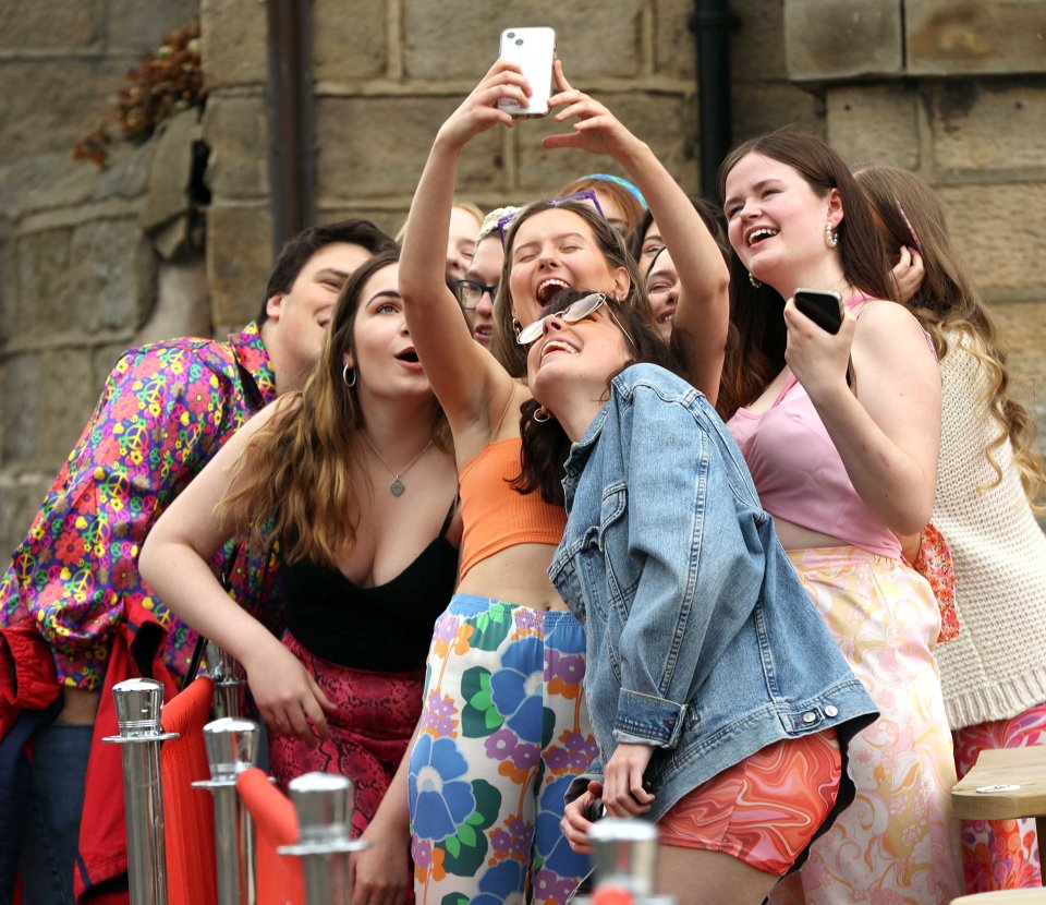 Grinning revellers pose for a pic in Leeds