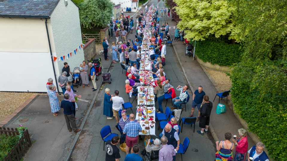 Around 200 people sat down for a tea party on a 60-metre-long table outside the village hall in Little Shelford in Cambridgeshire