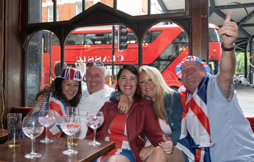 Debbie, Steve, Sam, Vera and Bert draped in Union Flags in the pub