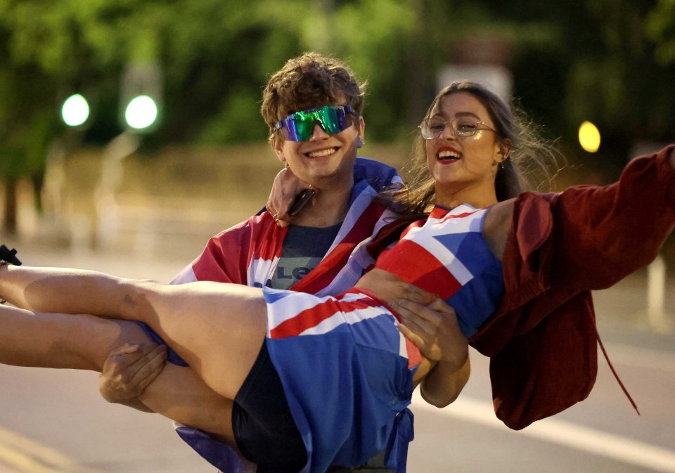 Young revellers post in Union Jack clothing in Leeds