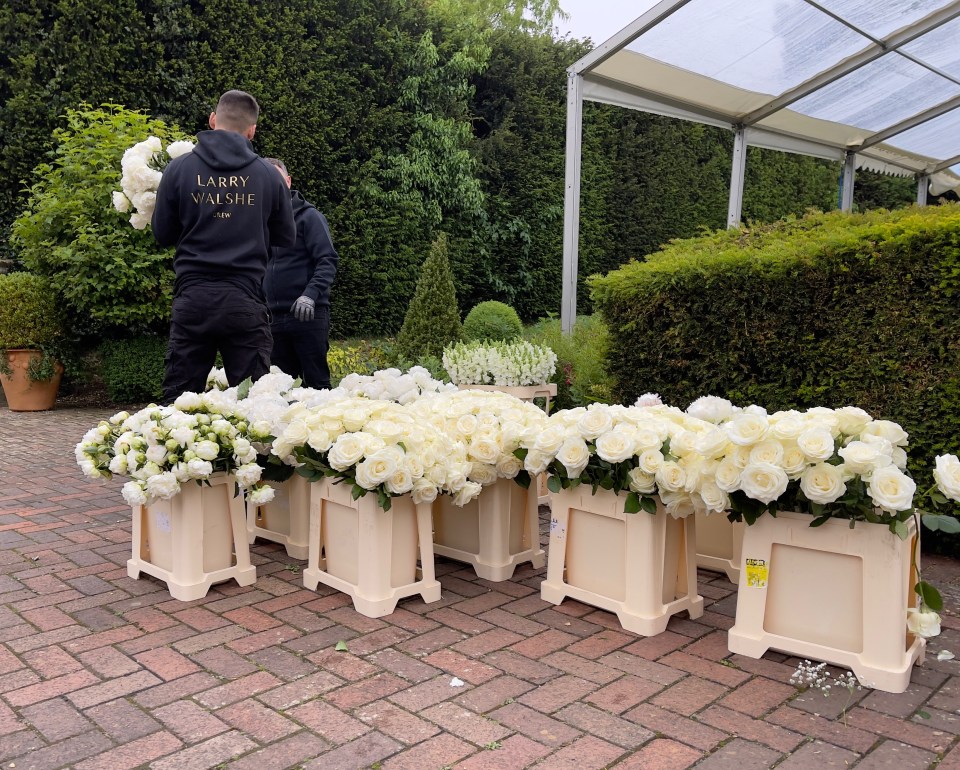 The couple were surrounded by white roses at the ceremony