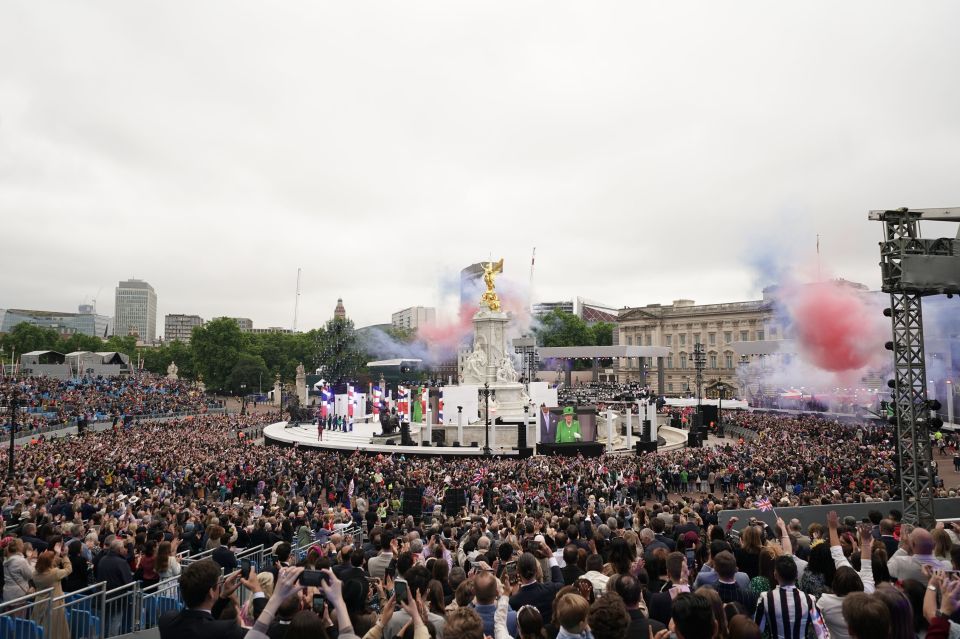 A lip reader said the Queen was surprised by red, white and blue smoke which erupted over the crowds as the national anthem ended