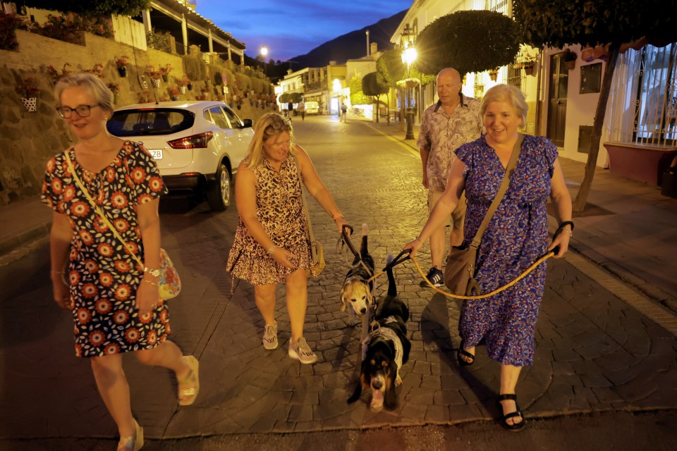 People walk as they are evacuated from a forest fire that broke out in Pujerra