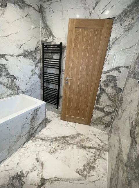 She has had the whole bathroom covered in glossy marble