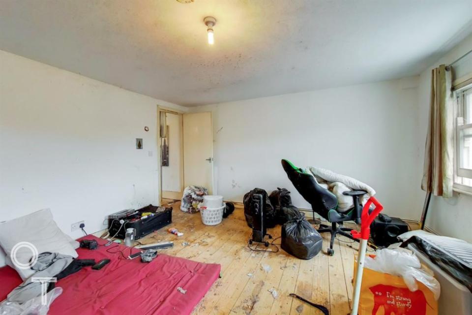 In one of the two-double bedrooms, a thin mattress has been dragged in for use as a makeshift bed