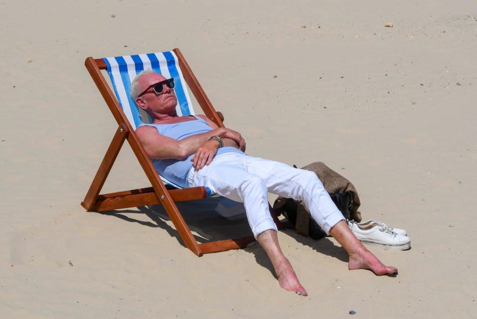 A sunbather on the beach at the seaside resort of Weymouth in Dorset