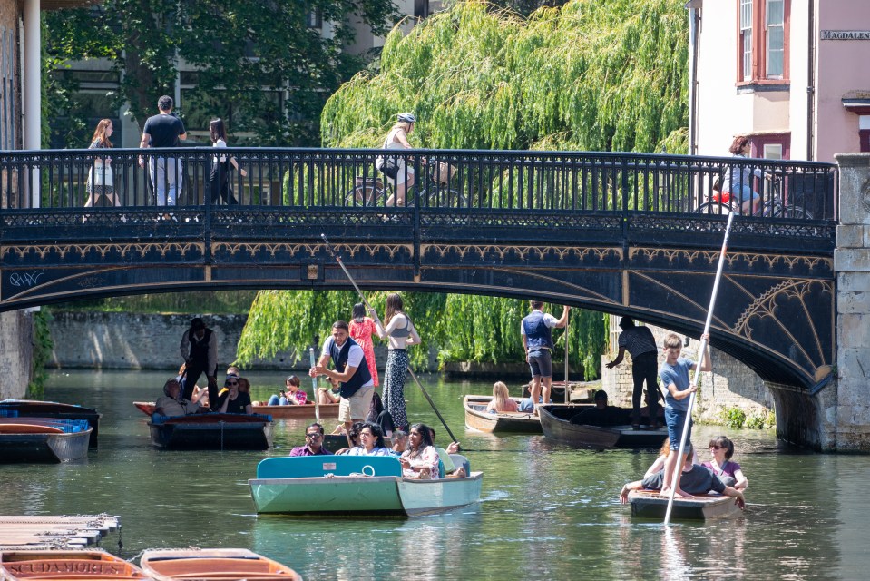 People enjoying the hot weather whilst out punting on the River Cam in Cambridge