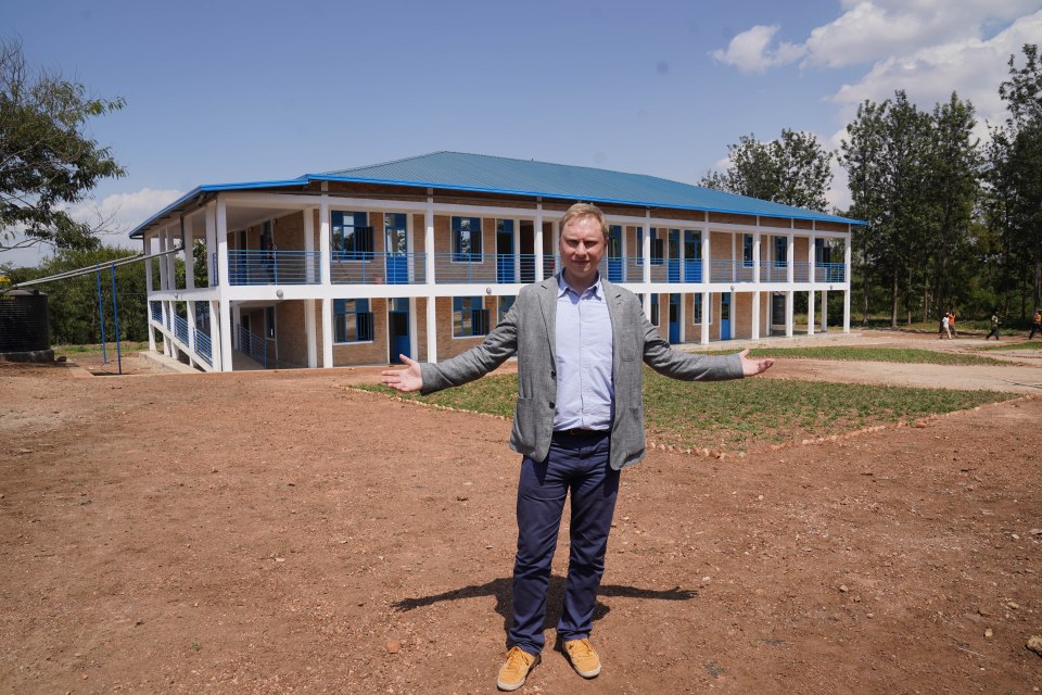 Chris Pollard stands outside the accommodation block at Gashora Transit centre