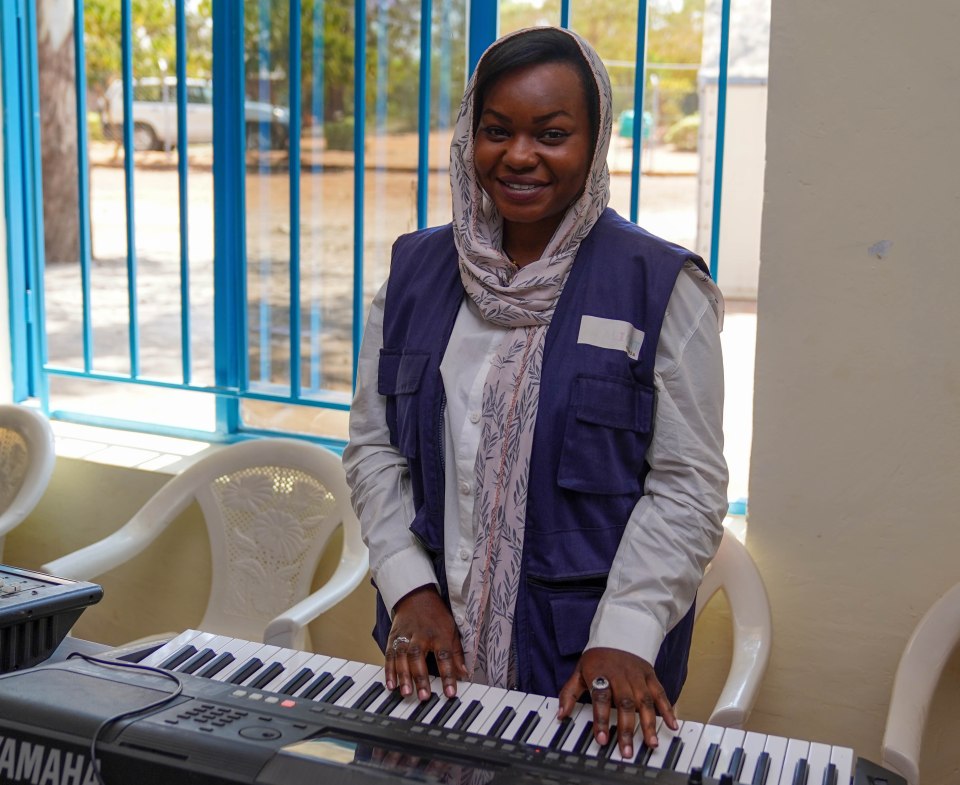 Reem Jamiel plays the piano during a music therapy session