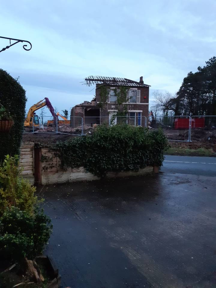 Workers demolished an old house, factory, and barn for 22 new homes and the tower