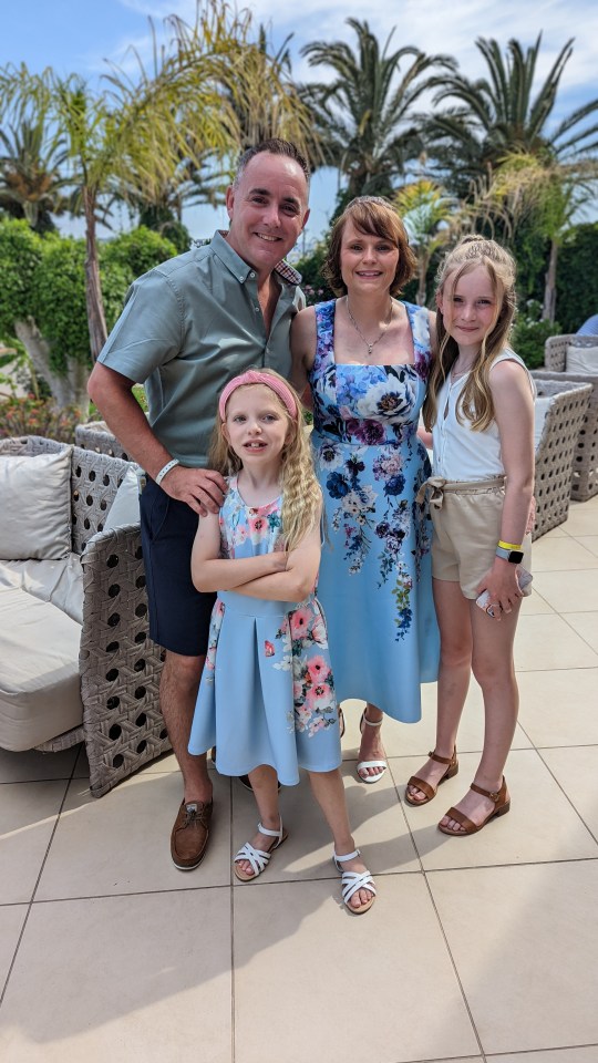 The couple with their two daughters after finally making it on holiday