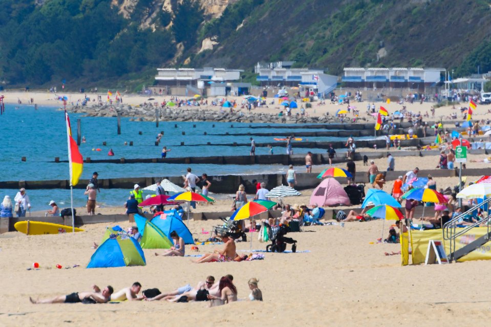 Sunbathers on the beach in Bournemouth in Dorset