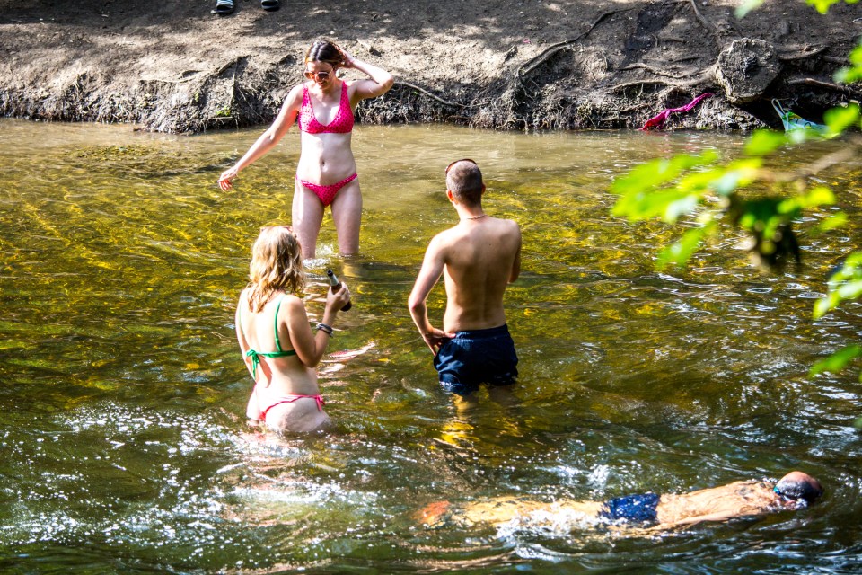 People enjoy the sunny weather at the canal in Hackney, east London