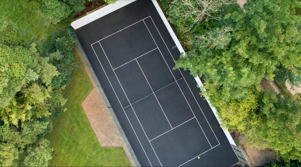 The tennis court in the sprawling gardens