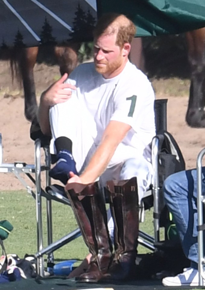 Less than impressed Harry takes his boots off following the defeat