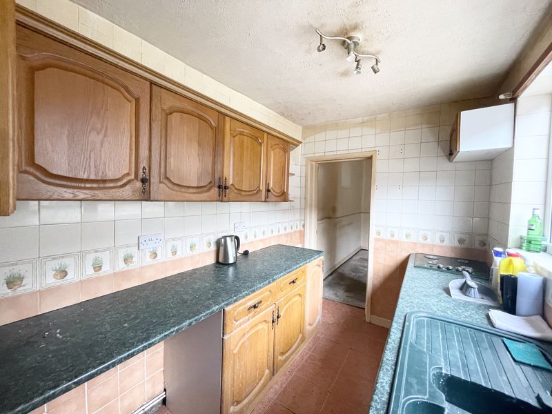 The knackered wooden and MDF surfaces appear beyond salvageable in the kitchen