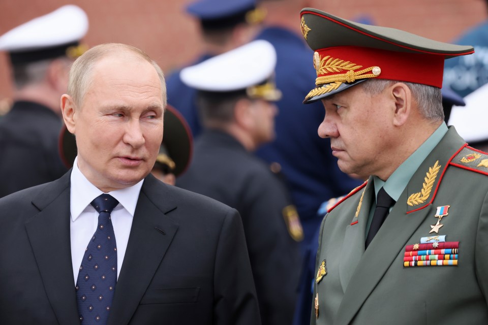 Vladimir Putin speaking to Russian defence minister Sergei Shoigu