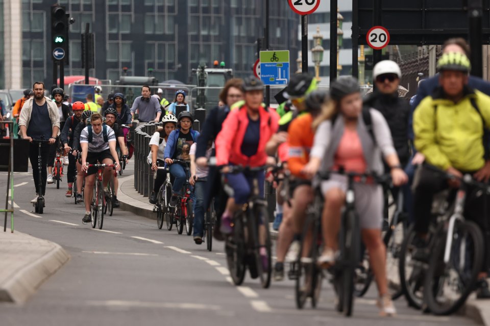 Cyclists pass though Parliament Square in Westminster on the second day of national rail strikes