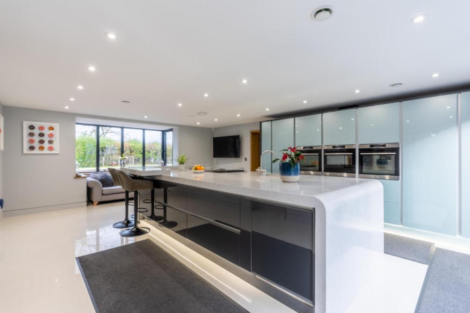 The modern and contemporary kitchen is dual aspect, with a large square bay to the front