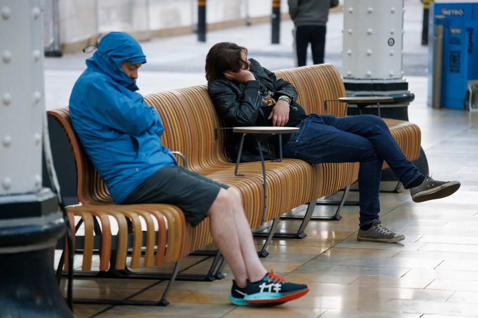 Brits snoozed on benches as they waited for today's first trains in Paddington Station