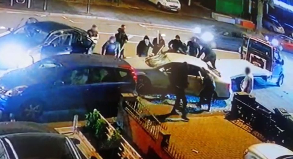 Up to 16 armed thugs began clubbing the car with weapons