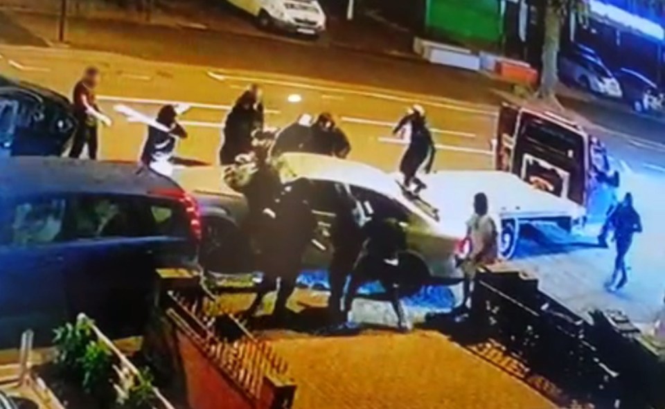 A flatbed lorry rammed the white car which was blocked in by a black motor