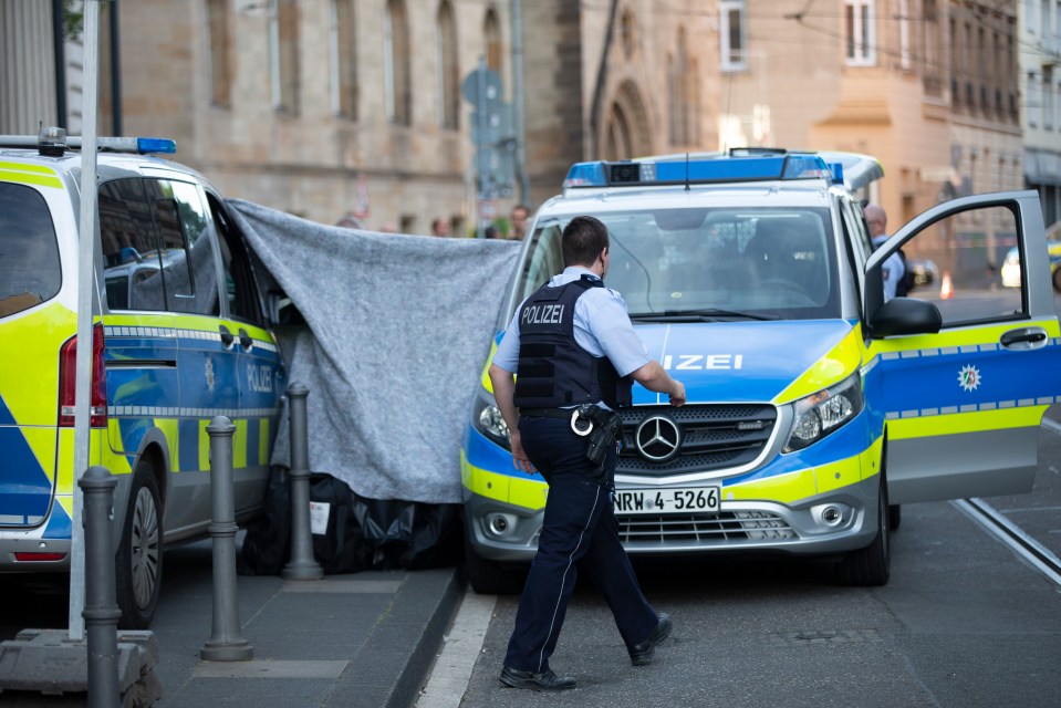 Forensics teams sealed off the street outside the Bonn district court