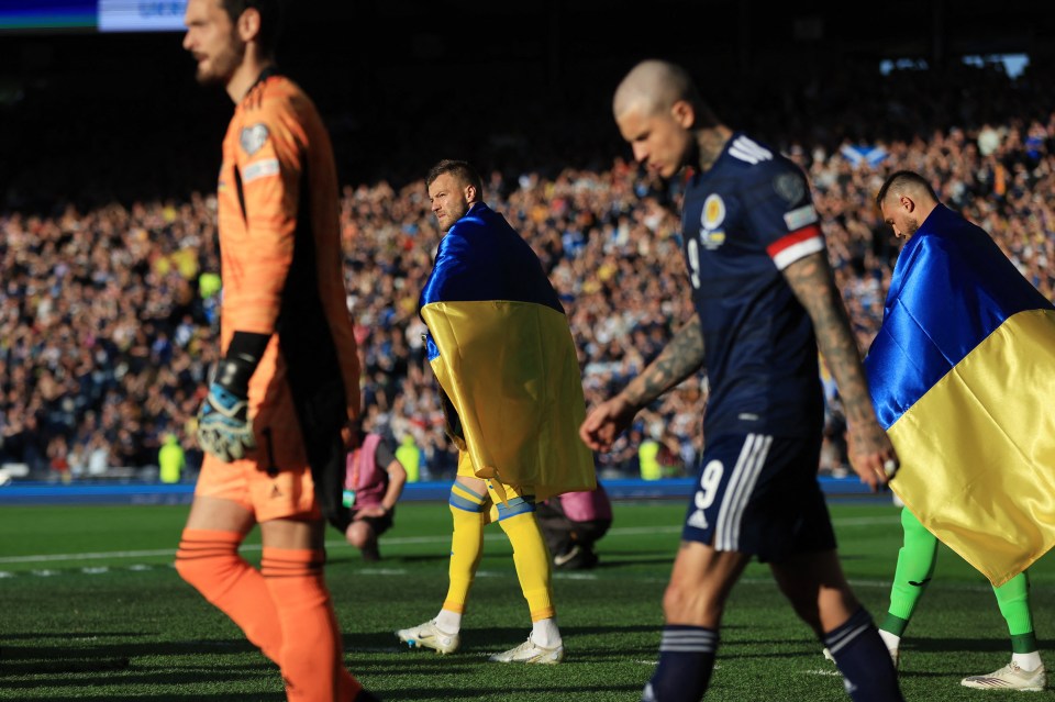 Yarmolenko leading out Ukraine at Hampden wearing Ukraine's colours