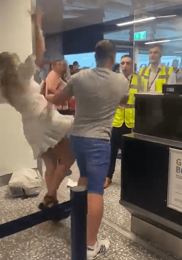 A plane passenger knocked his girlfriend to the ground while fighting airport workers