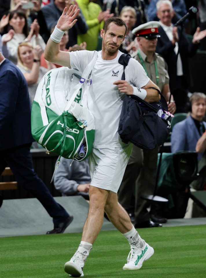 Andy Murray trudges off Centre Court following his defeat by John Isner