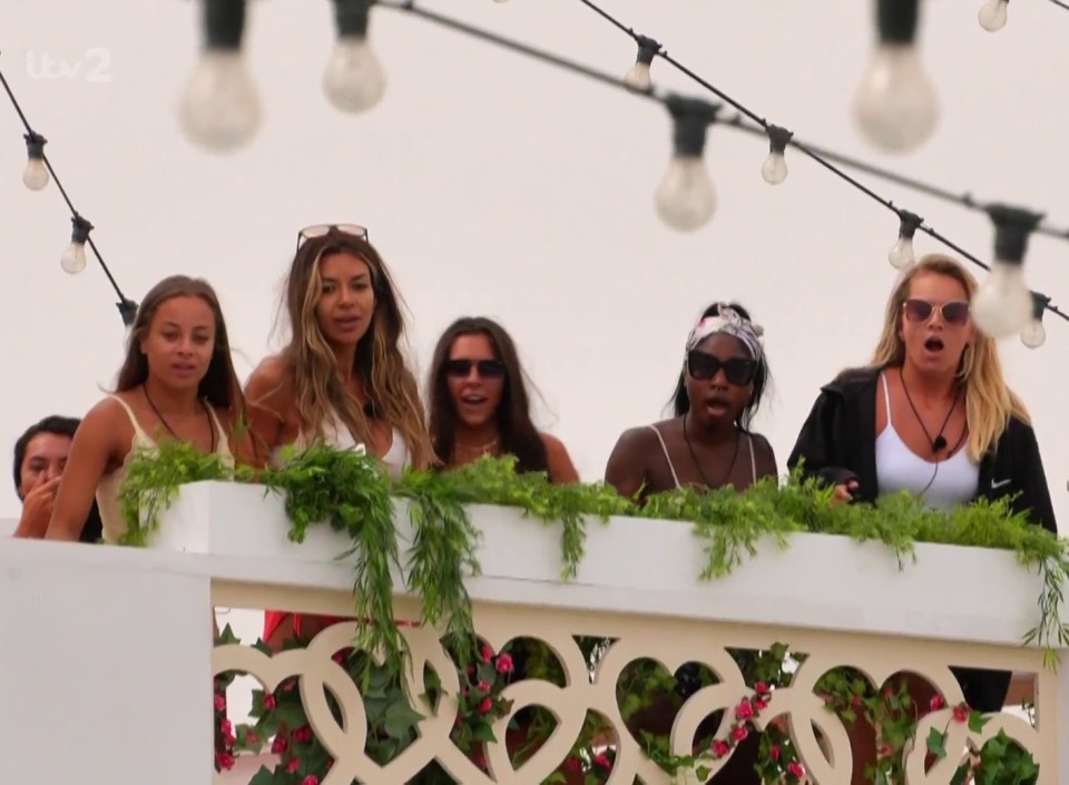 The girls looked shocked as she perched on a sun lounger in the garden