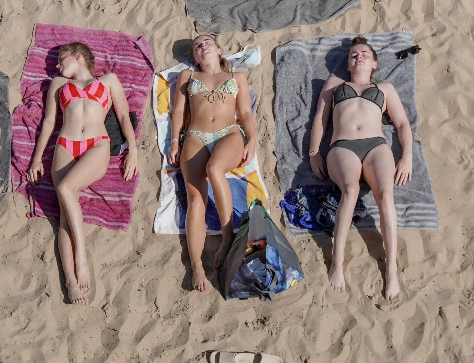 Brits enjoyed soaking up the sun on the sand at Cullercoats Bay, North Tyneside