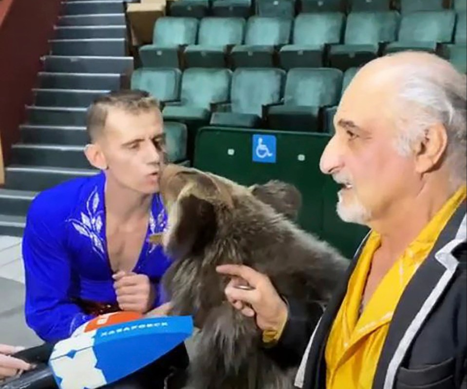 The ringmaster and trainer finally got the bear under control by each feeding it treats