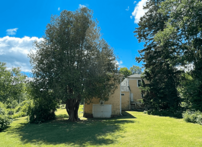 The house sits on 1.5 acres, with gravel access and a parking area