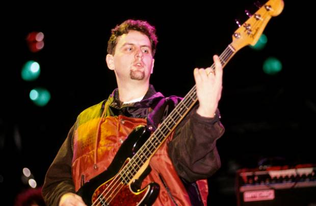 Paul Ryder of Happy Mondays playing bass guitar.