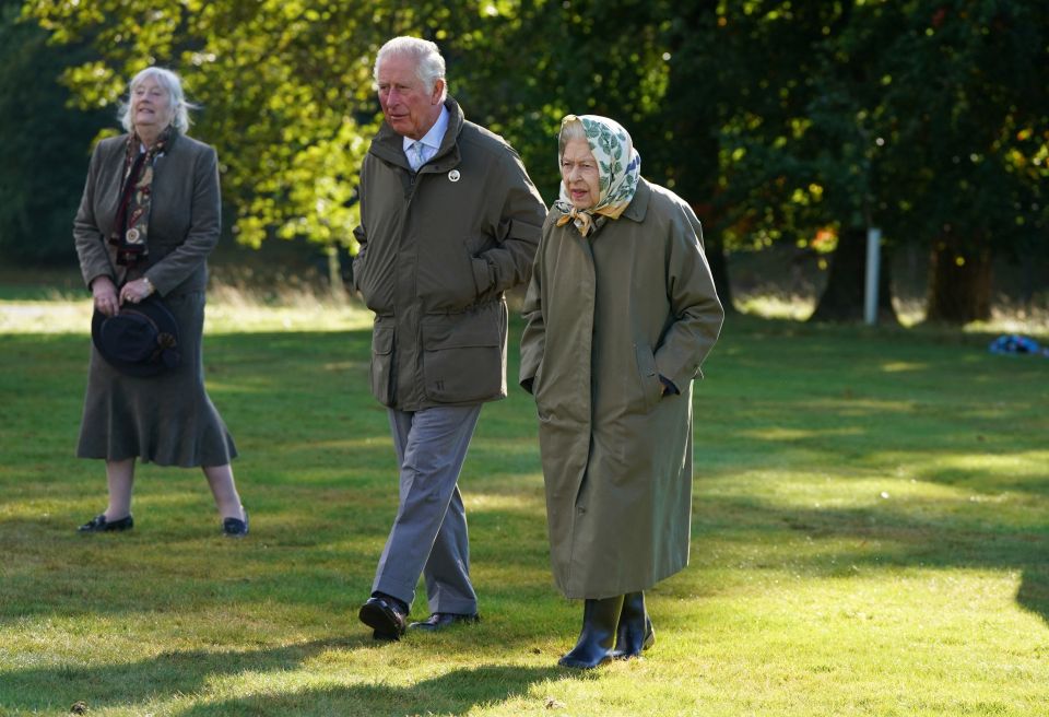 Prince Charles and the monarch walking to the Balmoral Cricket Pavilion in 2021