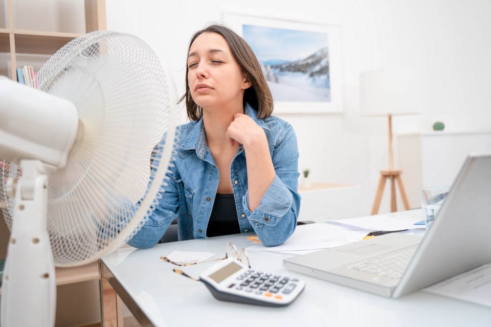 Woman feeling sweat and refreshing during summer heatwave