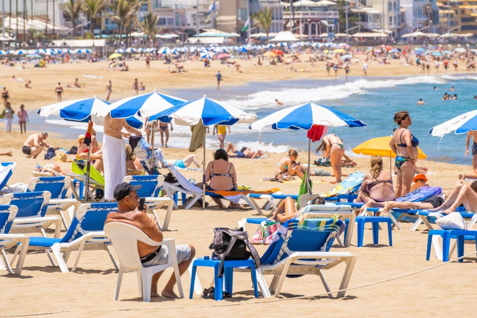 Tourists on the city beach in Las Palmas on Gran Canaria