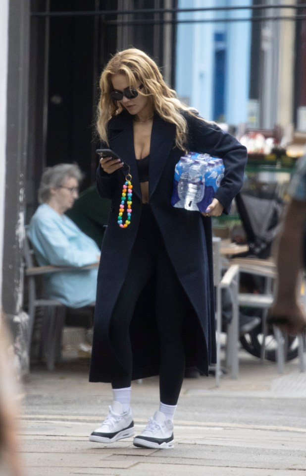 Rita Ora, 31, who has spent much of the past two years in Los Angeles and Australia, wore a black sports top and overcoat as she lugged bottles of water