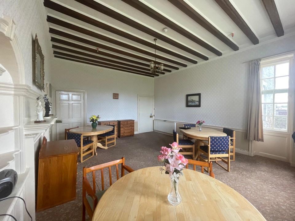 The property's dining room with original beamed ceiling and wooden doors