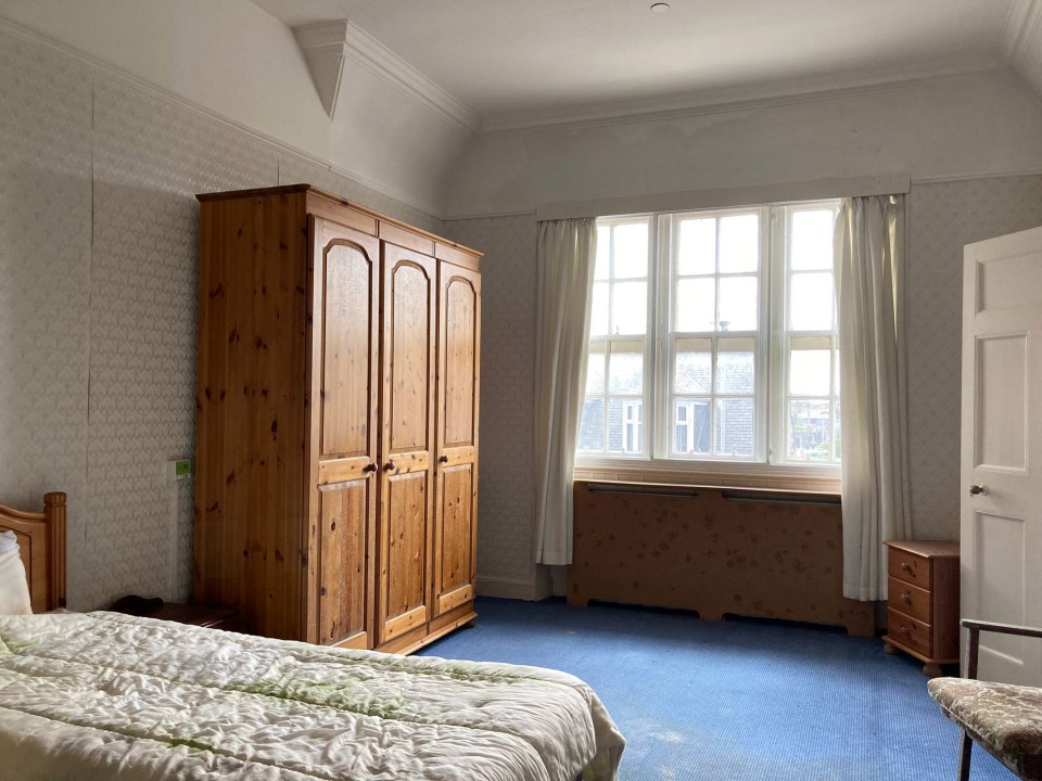 One of the 16 bedrooms showing original features and furnishings