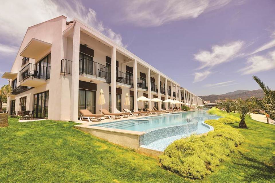 A natural lagoon surrounds the Jiva Beach Resort, and glass-sided bridges connect the various structures