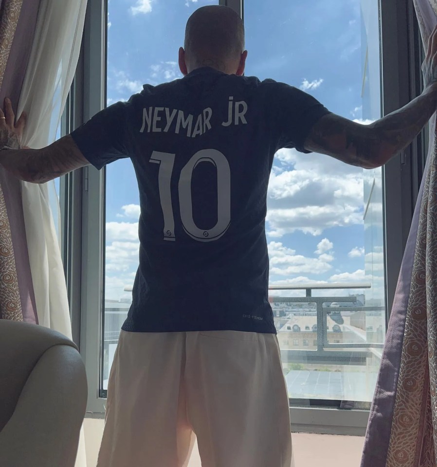 Dani Alves poses in Neymar’s PSG shirt as he trolls fans